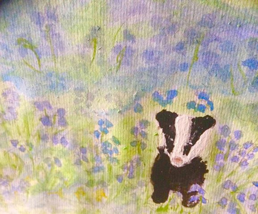 Learner painting of skunk amongst blue flowers 