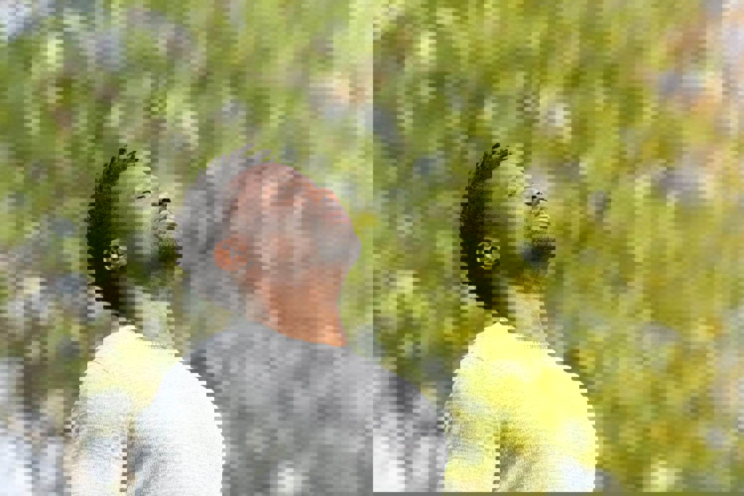 Man looking up to sky with eyes closed