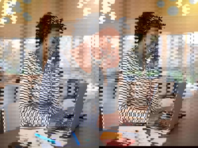 Woman smiling on laptop