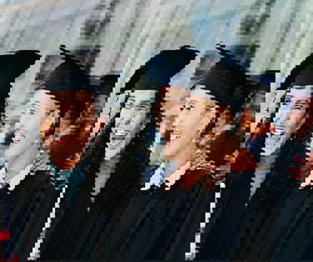 Two graduates smiling