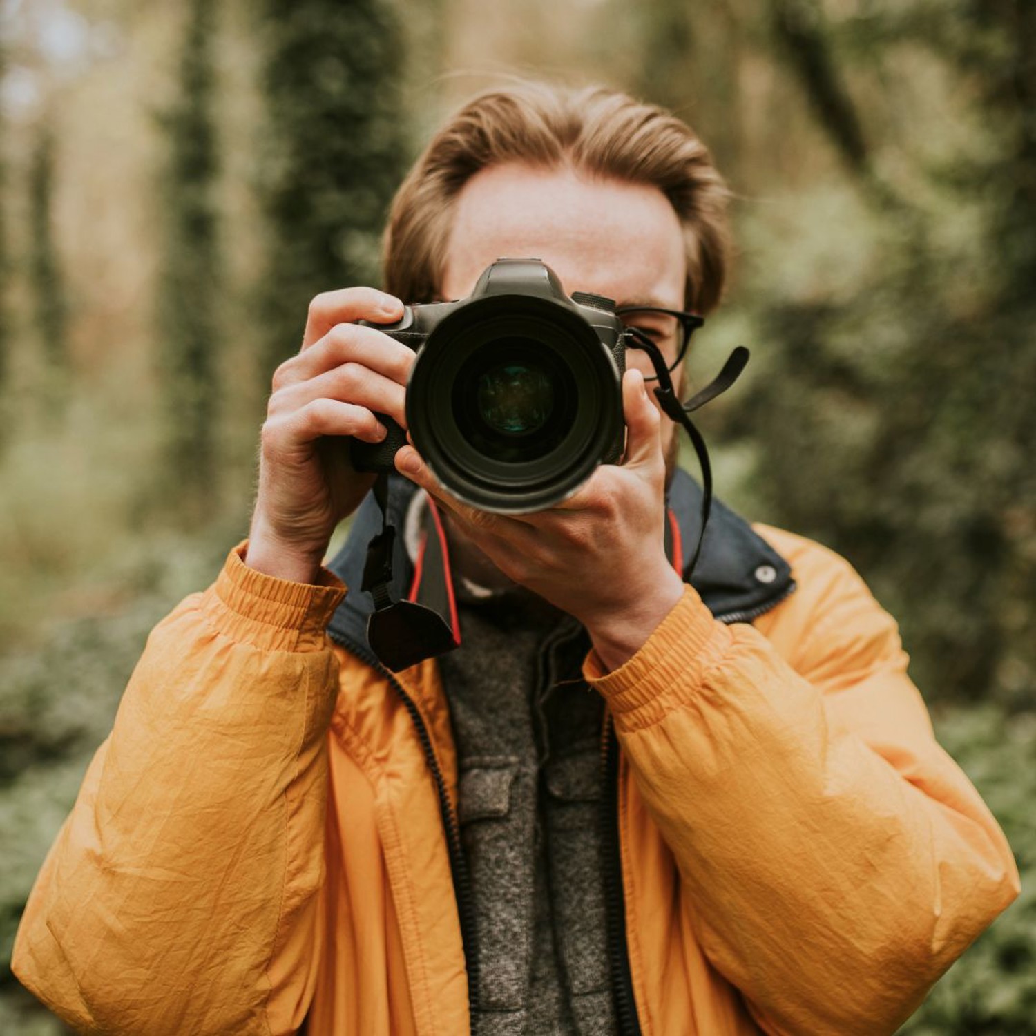 Man taking photos in a forest
