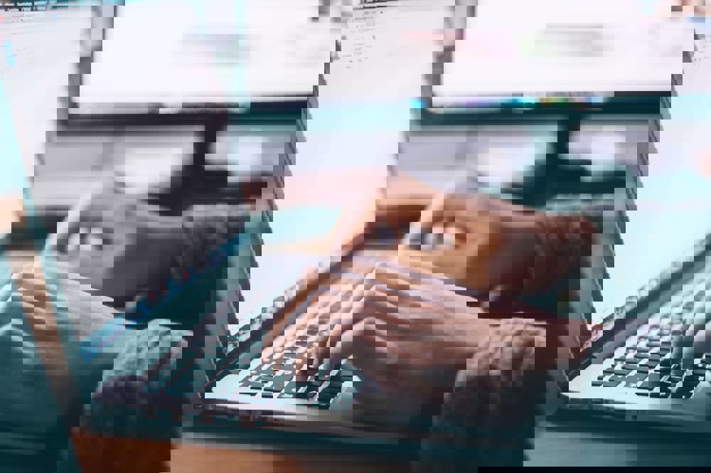 Typing on a laptop