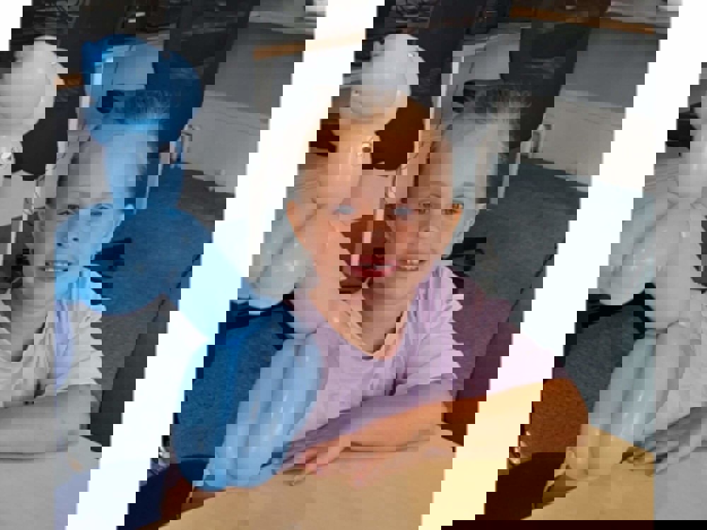 Girl smiling holding balloon animal