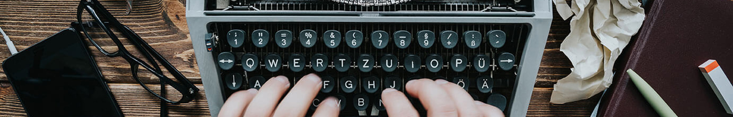 Hands typing on a typewriter