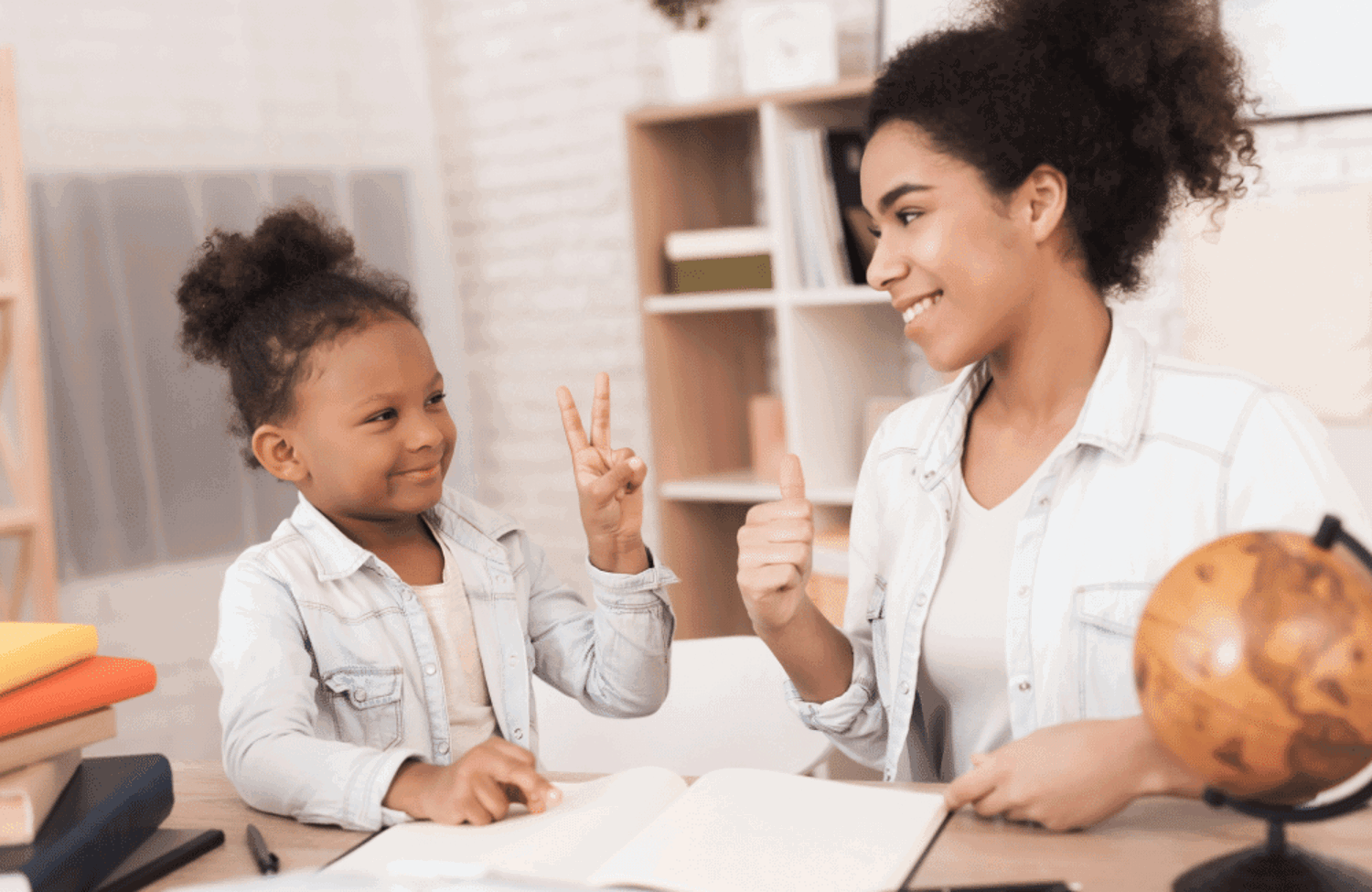 Young girl doing peace sign to woman with thumbs up