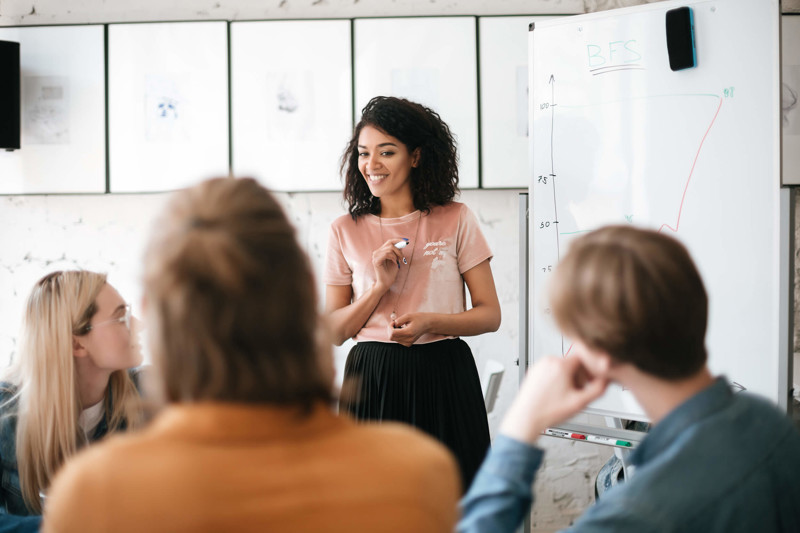 Women giving a presentation on whiteboard