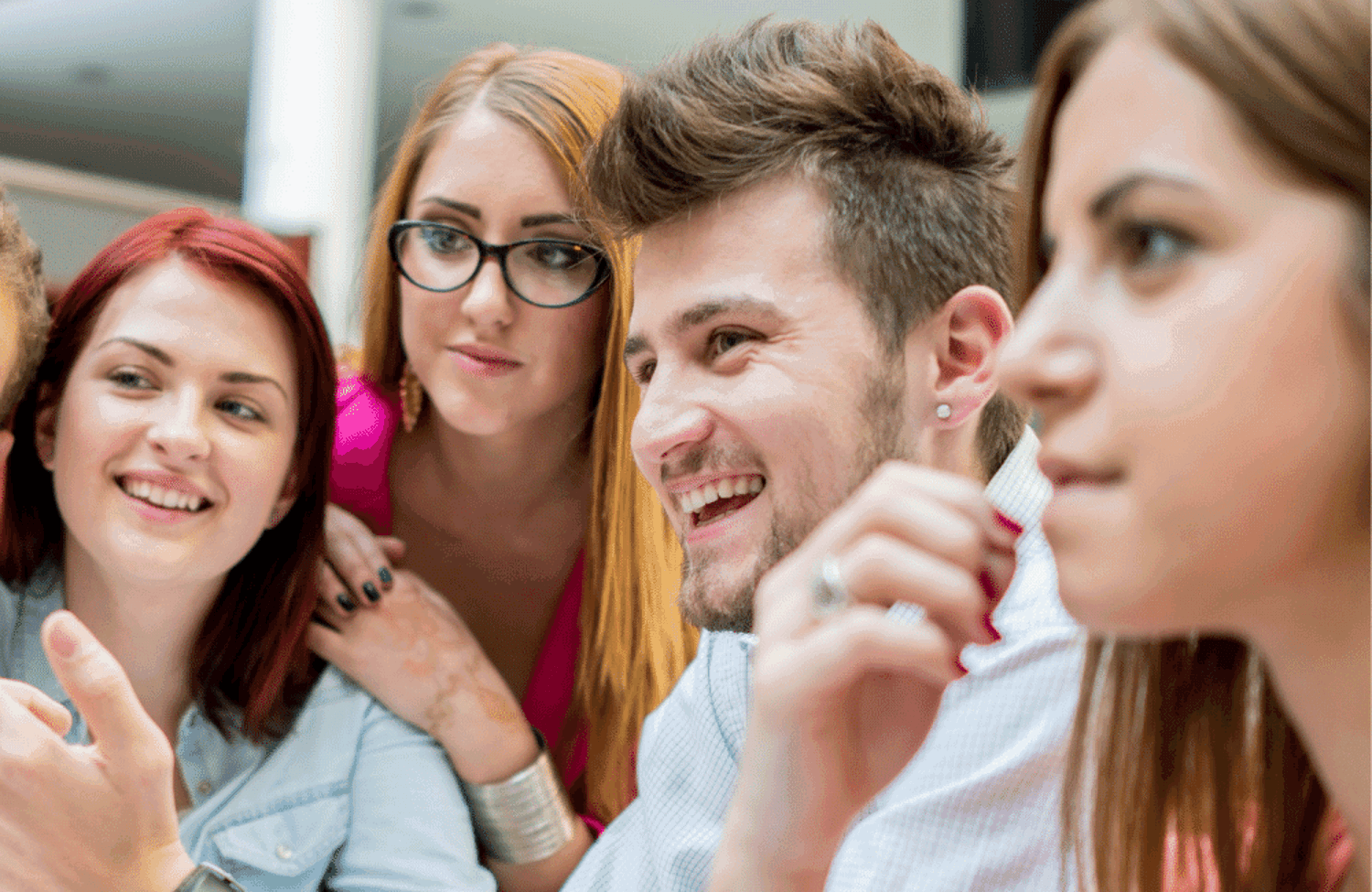 Group of smiling teenagers looking at something