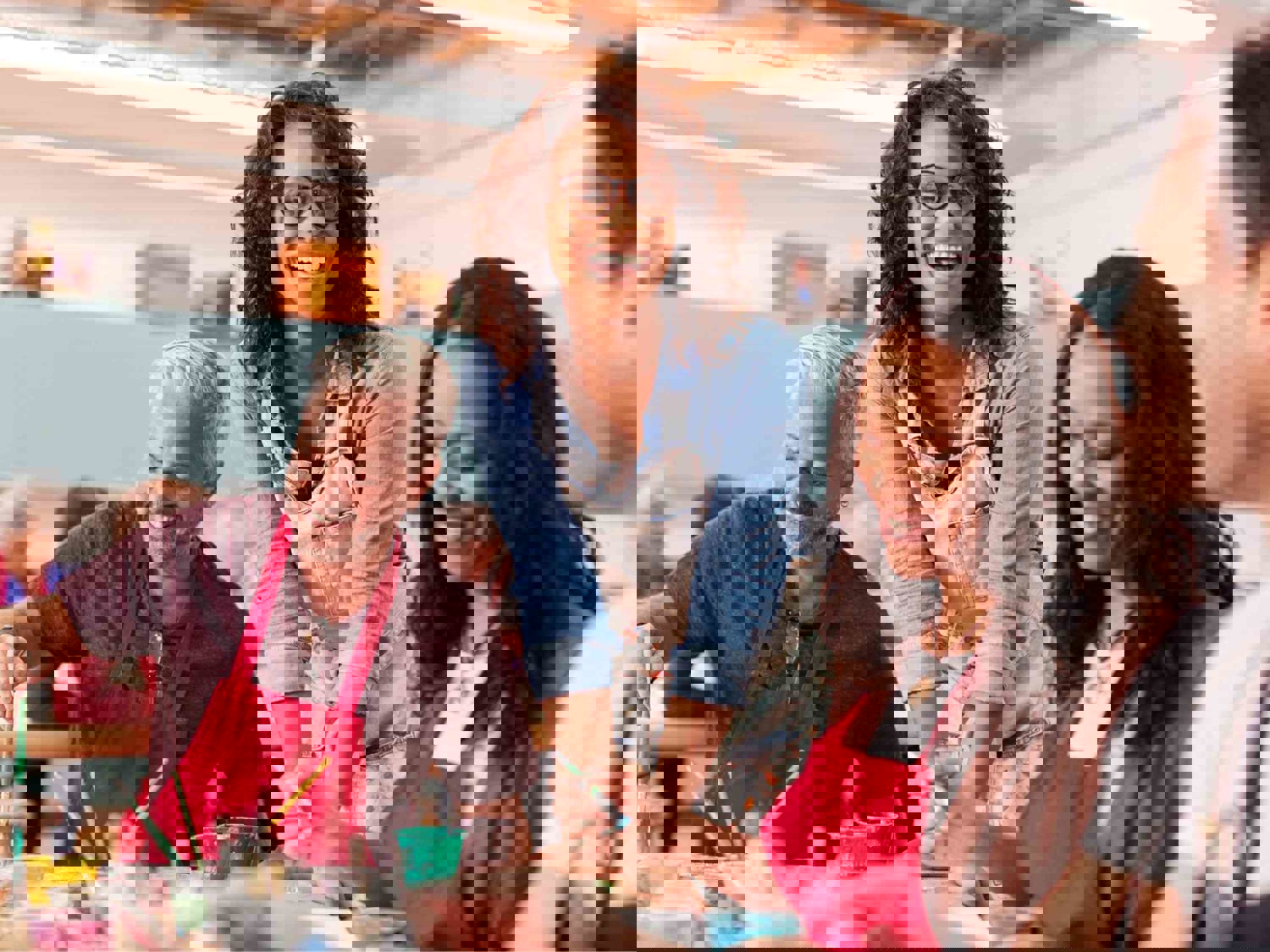 Adults smiling and painting