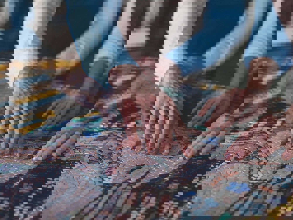 Two people creating a mosaic