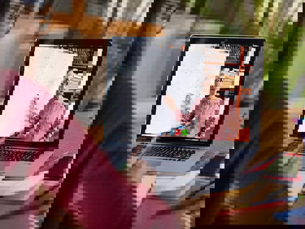 Woman on laptop watching online class