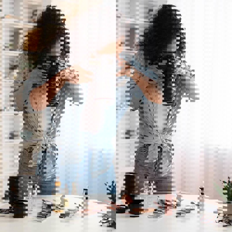 Person taking photos of makeup on a table