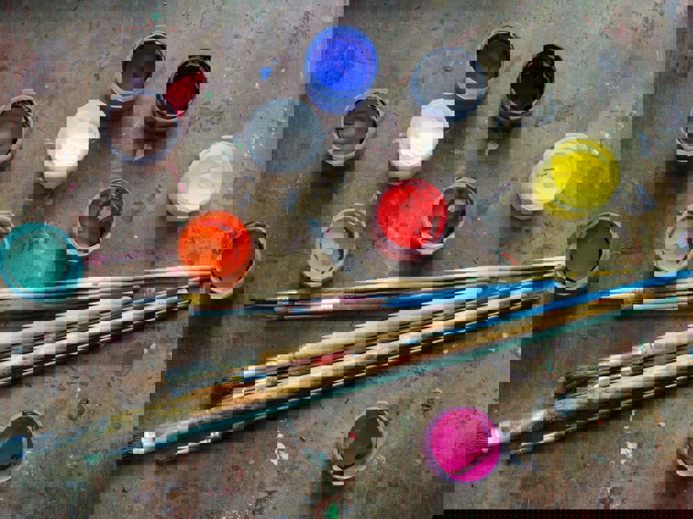 Brushes with tubs of coloured paint