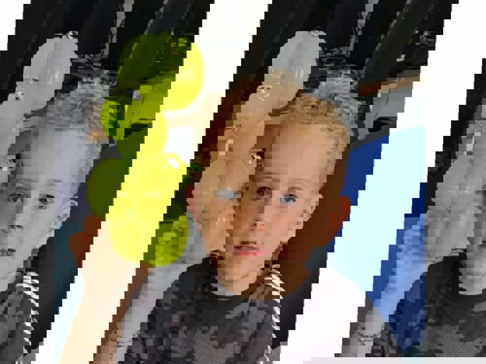 Boy holding balloon animal