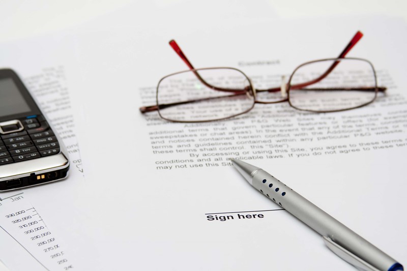 Glasses and a pen on documents
