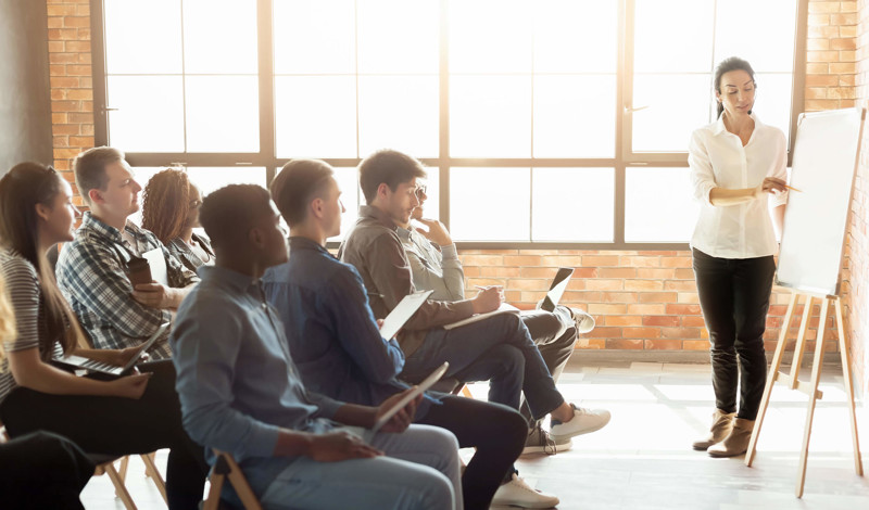 A group of adults in a presentation meeting